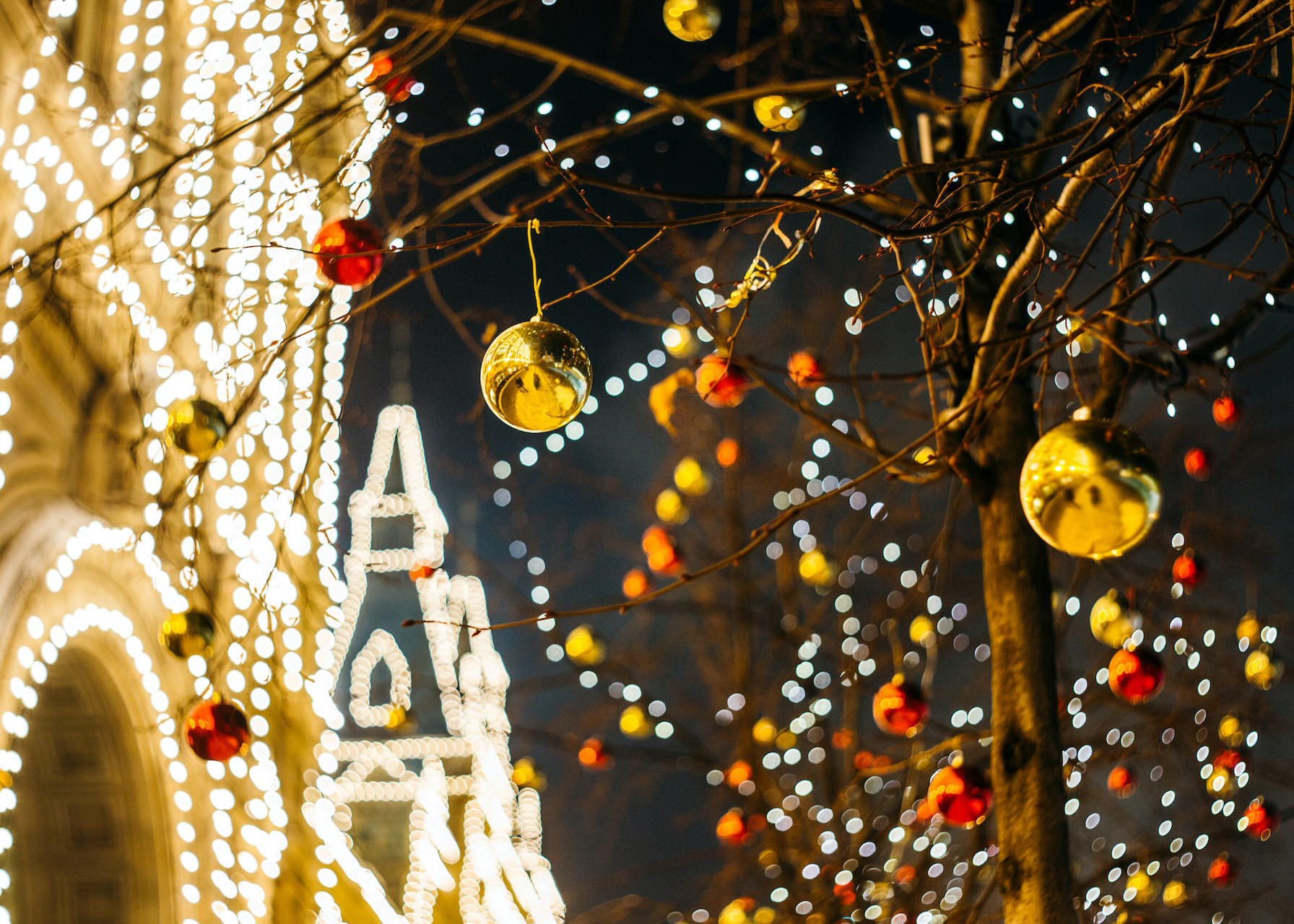 Christmas lights and ornaments on trees near Buckingham Palace.
