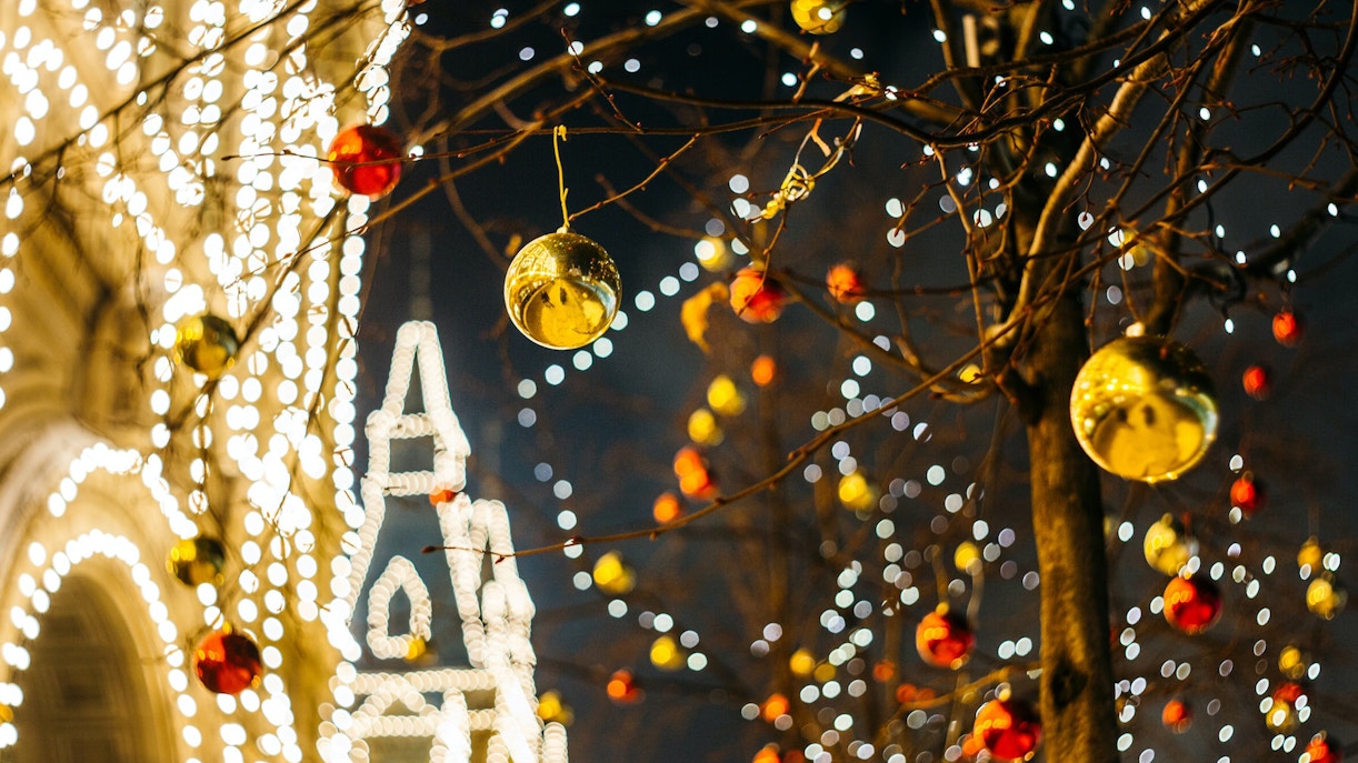 Christmas lights and ornaments on trees near Buckingham Palace.