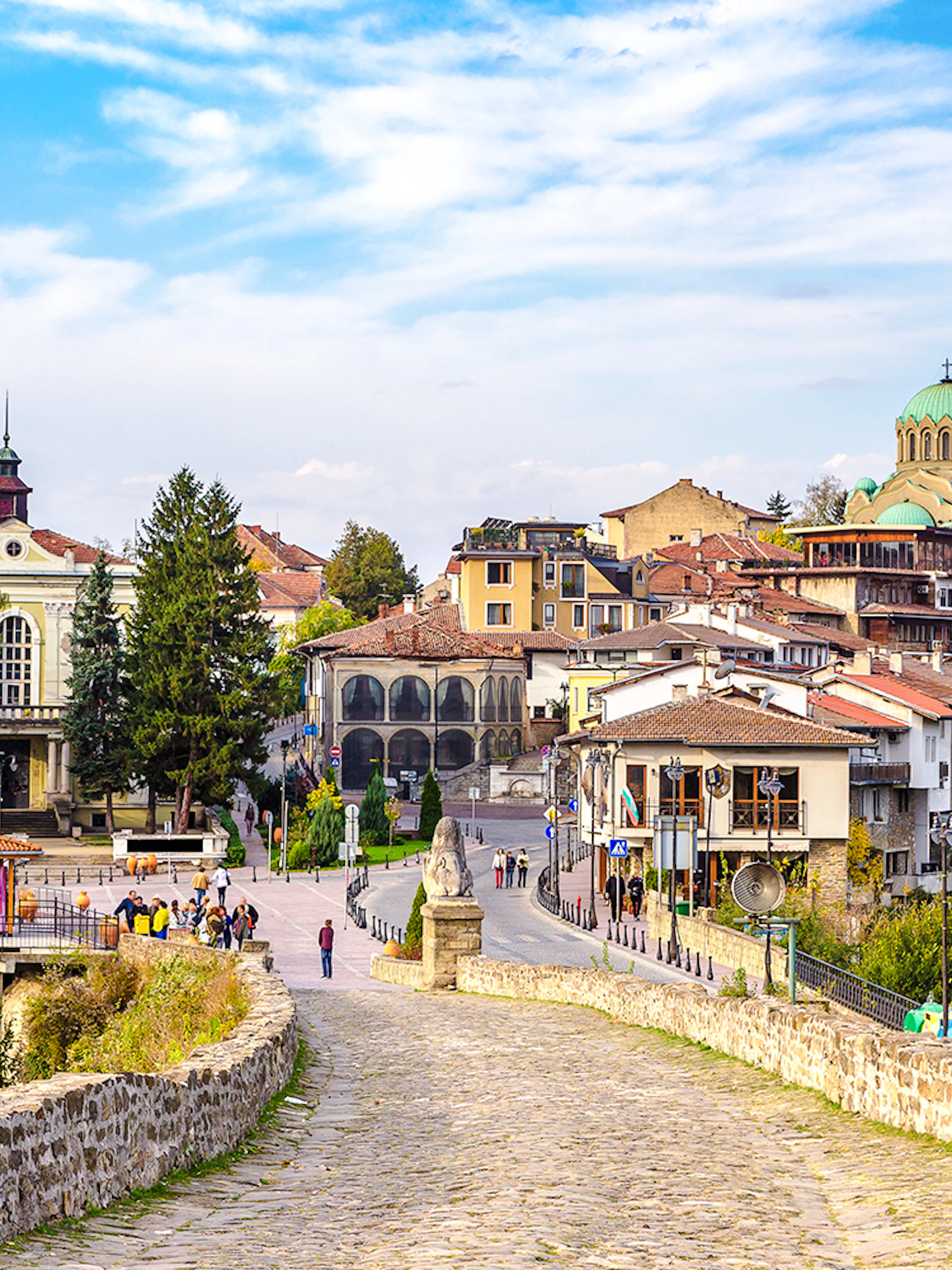Tsarevets Fortress path leading to Veliko Tarnovo's historic buildings and church.