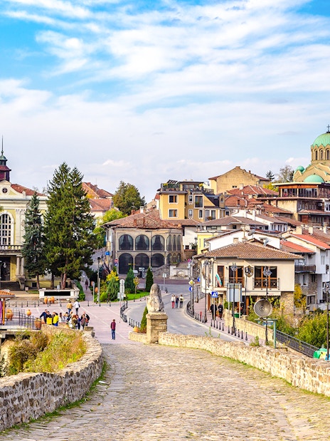 Tsarevets Fortress path leading to Veliko Tarnovo's historic buildings and church.