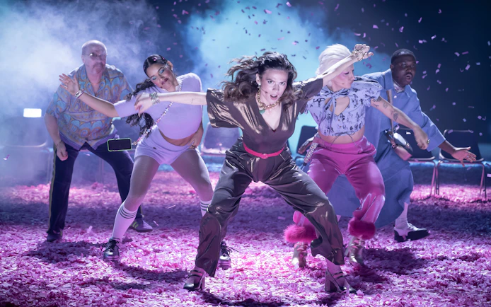 Performers dancing energetically on stage during Much Ado About Nothing show, Broadway.