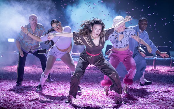Performers dancing energetically on stage during Much Ado About Nothing show, Broadway.