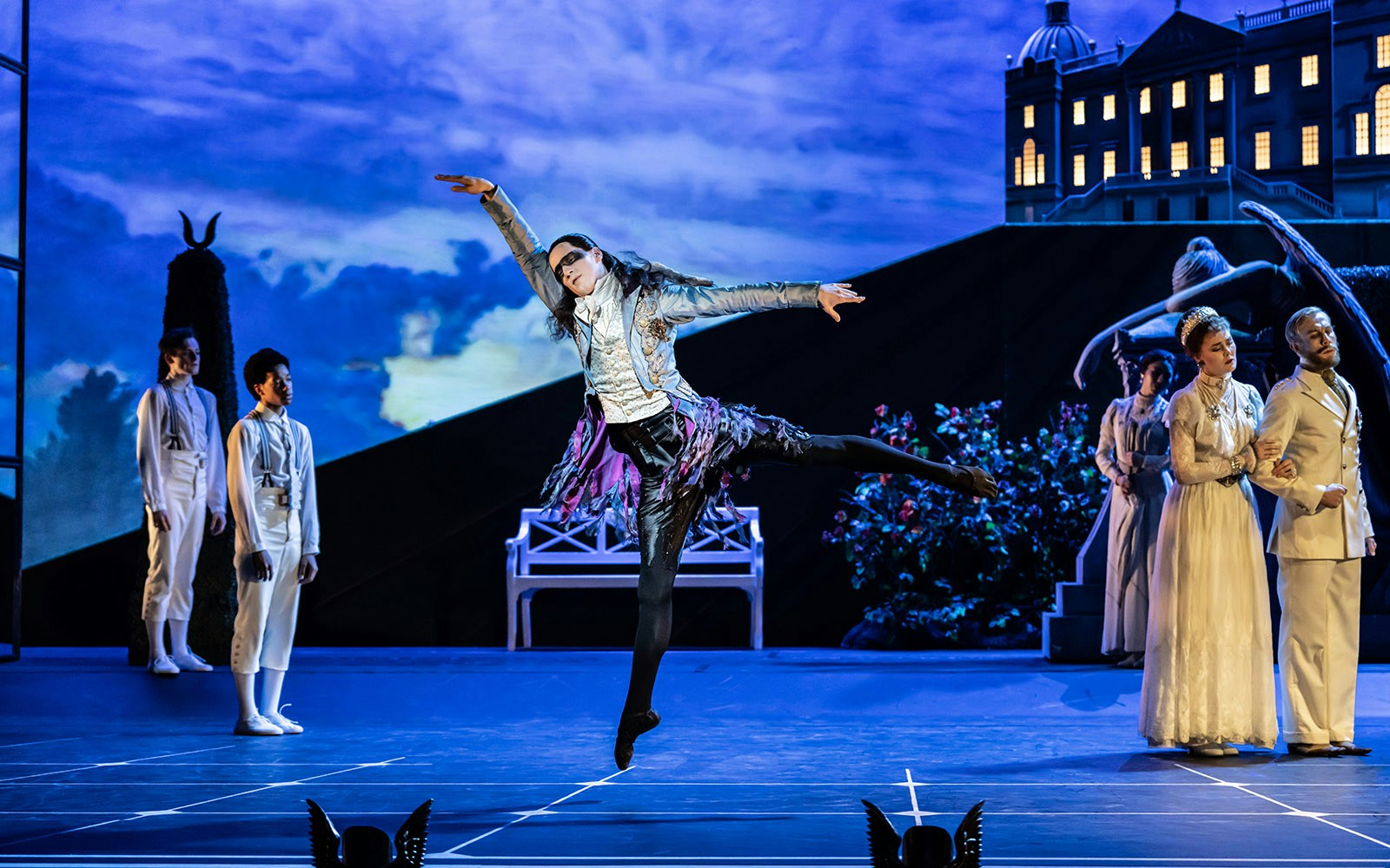 Dancer performing in Matthew Bourne's Sleeping Beauty with a dramatic backdrop.