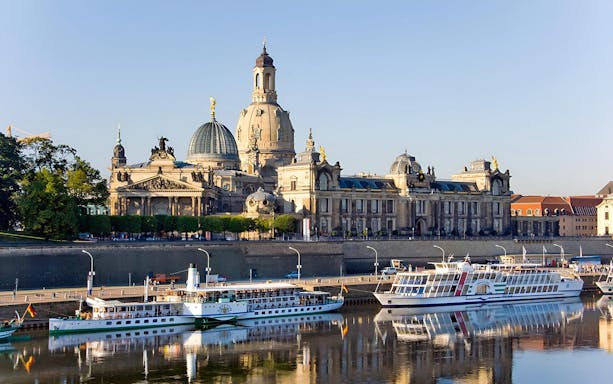 Dresden skyline with Frauenkirche and ships on the Elbe River for city tour.