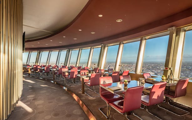 Tables set in the Berlin TV Tower restaurant with panoramic city views.