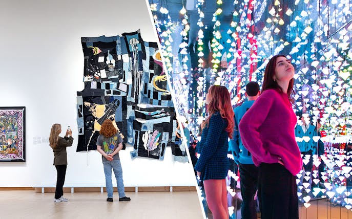 Visitors viewing modern art installations at Stedelijk Museum Amsterdam.