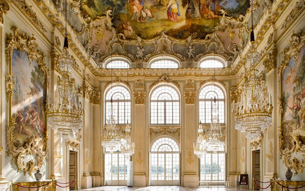 Interior of Nymphenburg Palace's Great Hall with chandeliers and frescoes, Munich City Pass.