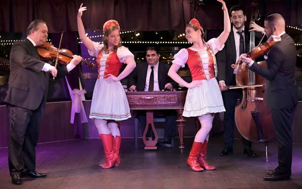 Musicians and dancers performing on a Budapest Danube cocktail cruise with live music.