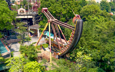 Sunway Lagoon Theme Park pirate ship ride surrounded by lush greenery.