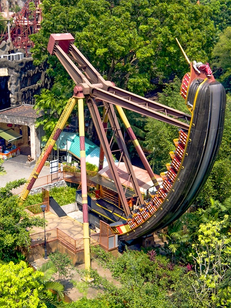 Sunway Lagoon Theme Park pirate ship ride surrounded by lush greenery.