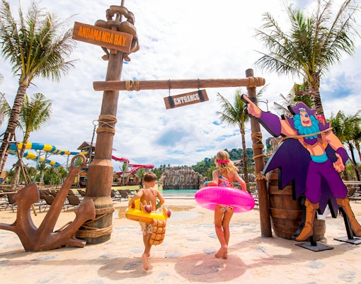Children entering Andamanda Bay water park in Phuket with colorful floats.