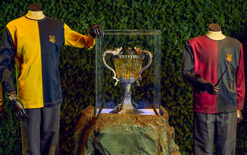 Triwizard Tournament Cup display with Hogwarts uniforms at Warner Bros. Studio Tour London.