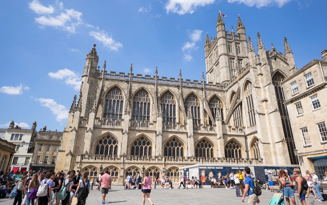 Bath Abbey with tourists in Bath, England, part of the Bridgerton Tour and Bath City Highlights.