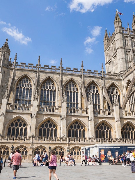 Bath Abbey with tourists in Bath, England, part of the Bridgerton Tour and Bath City Highlights.