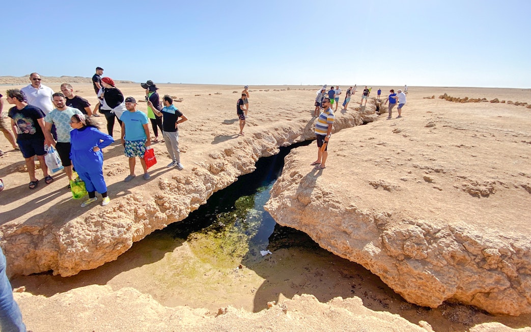 Visitors observing earthquake cracks at Ras Mohamed National Park, Egypt.