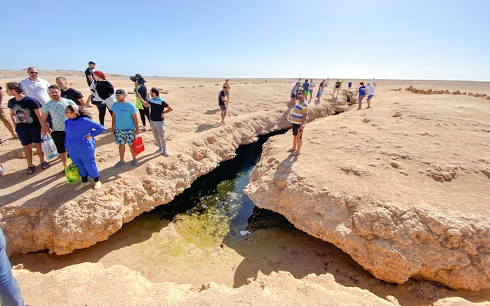 Visitors observing earthquake cracks at Ras Mohamed National Park, Egypt.