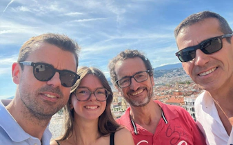 Group enjoying Nice cityscape during self-guided murder mystery game.