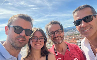 Group enjoying Nice cityscape during self-guided murder mystery game.