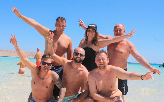 Group enjoying the beach on Orange Bay, Giftun Island, during a private speedboat tour from Hurghada.