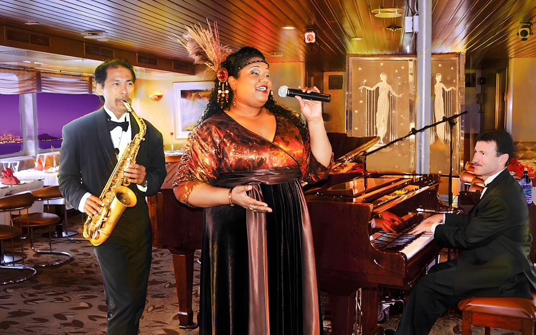 Performers at Nova Five Star 2 with singer, saxophonist, and pianist on stage.