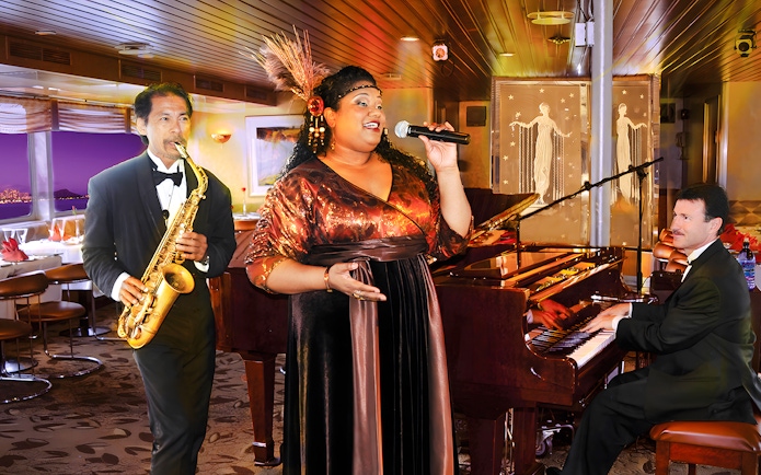 Performers at Nova Five Star 2 with singer, saxophonist, and pianist on stage.