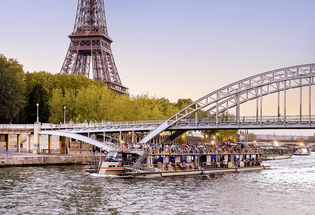 Seine River cruise boat near Eiffel Tower, Paris, France.