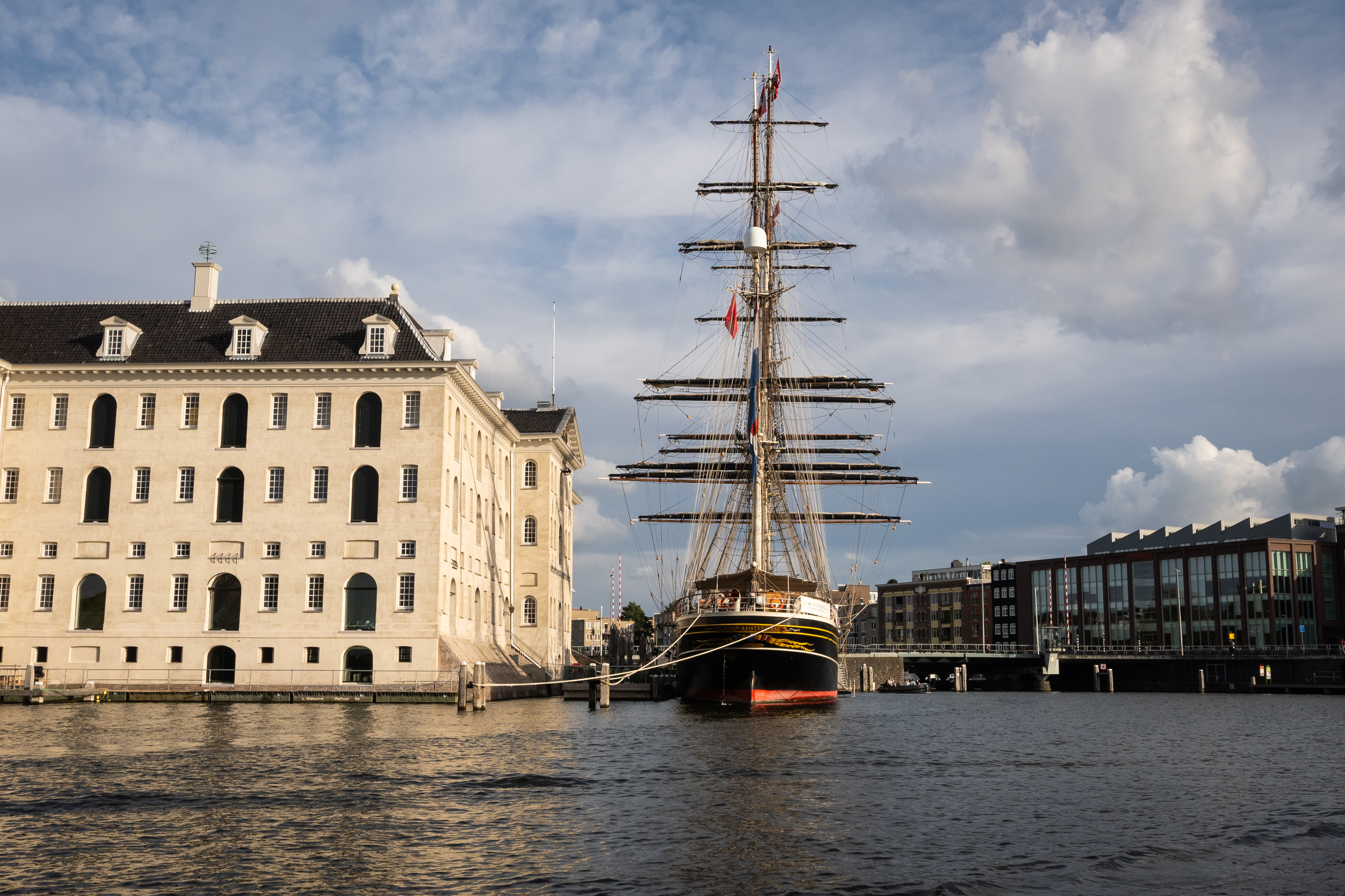 Clipper Stad Amsterdam docked at the National Maritime Museum, Amsterdam, with museum building in view.