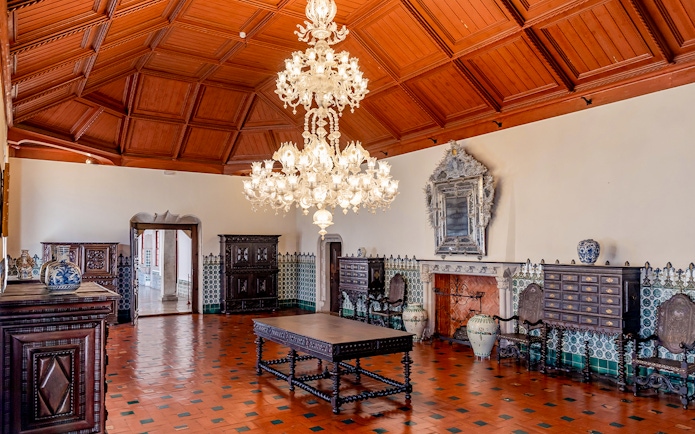 Sintra National Palace Manueline Room with ornate chandelier and tiled walls.