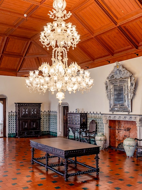 Sintra National Palace Manueline Room with ornate chandelier and tiled walls.