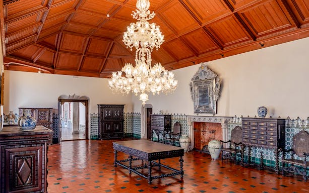 Sintra National Palace Manueline Room with ornate chandelier and tiled walls.
