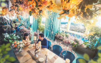 Dining experience at Shangri-La Garden, Taipei 101, with floral decor and city view.