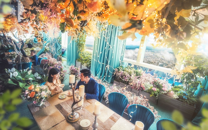 Dining experience at Shangri-La Garden, Taipei 101, with floral decor and city view.