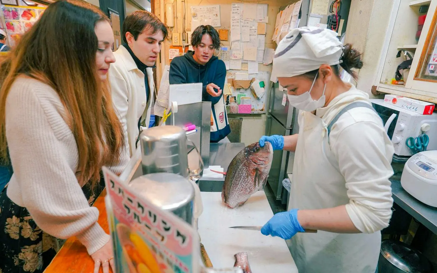 Chef preparing fish for guests at Tsukiji Fish Market, Tokyo.