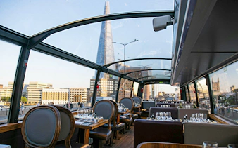 Dining area inside Bustronome London with view of the Shard.