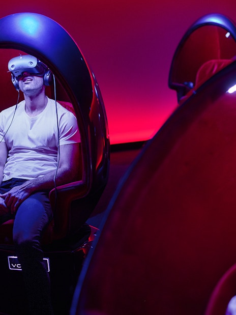 VR experience at Voyager Theatre with person in headset and immersive seating.