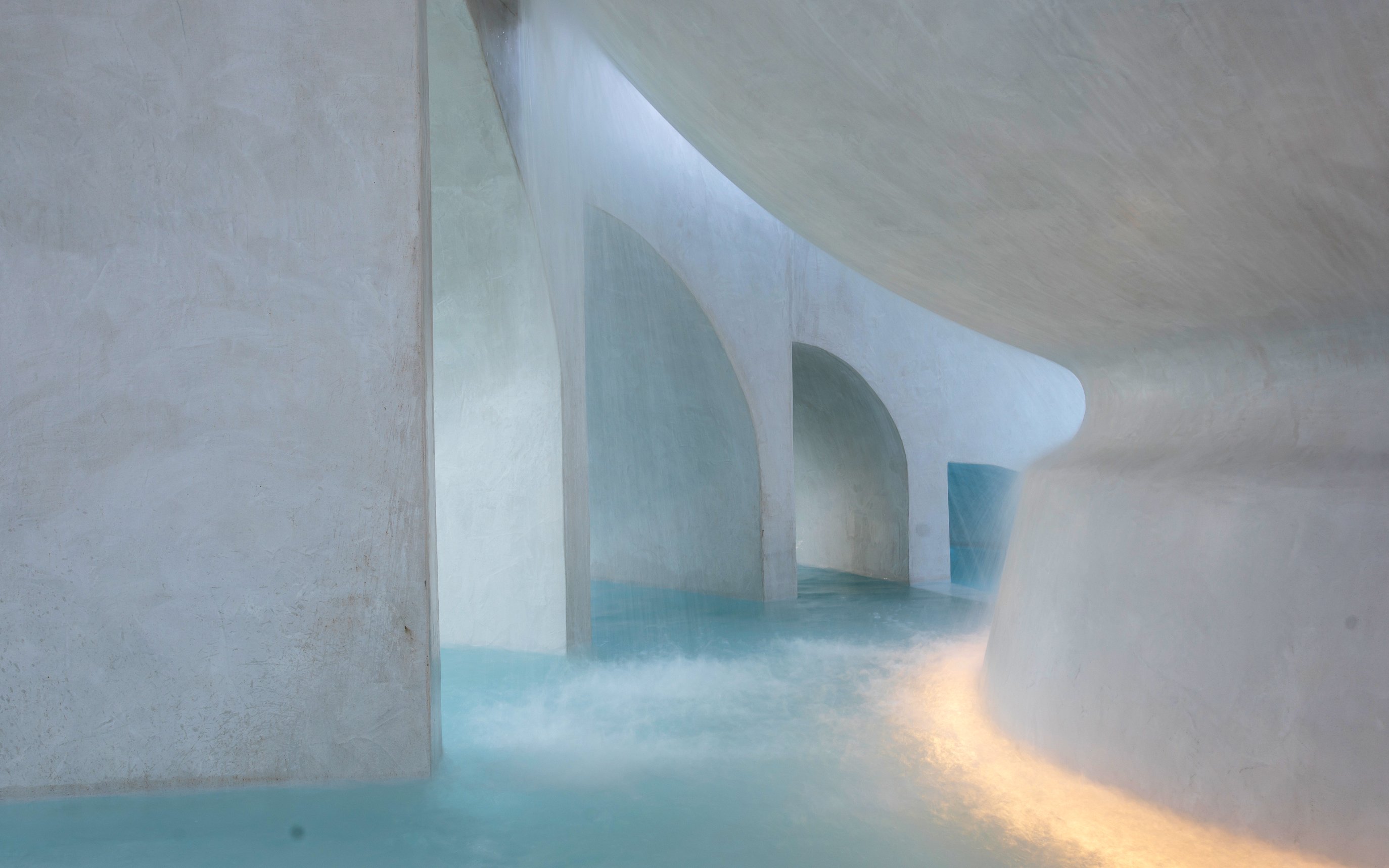 Indoor pool with arched architecture at Caldea thermal leisure center, Andorra.