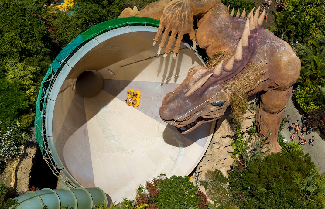 Cyclone slide with dragon sculpture at Siam Park, water swirling around the ride.