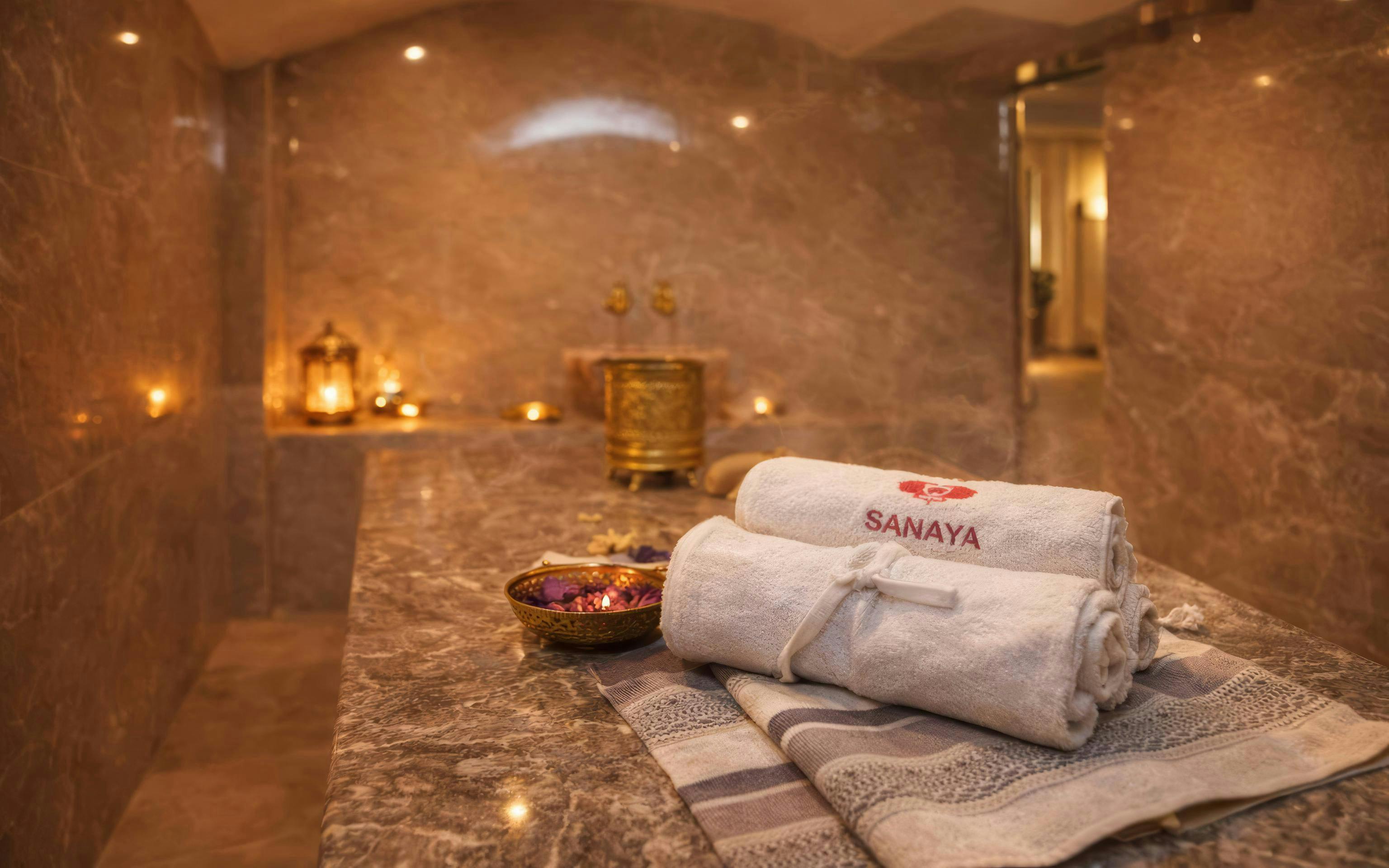 Luxurious hammam interior with towels and candles in Agadir spa.