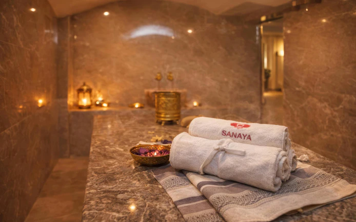 Luxurious hammam interior with towels and candles in Agadir spa.