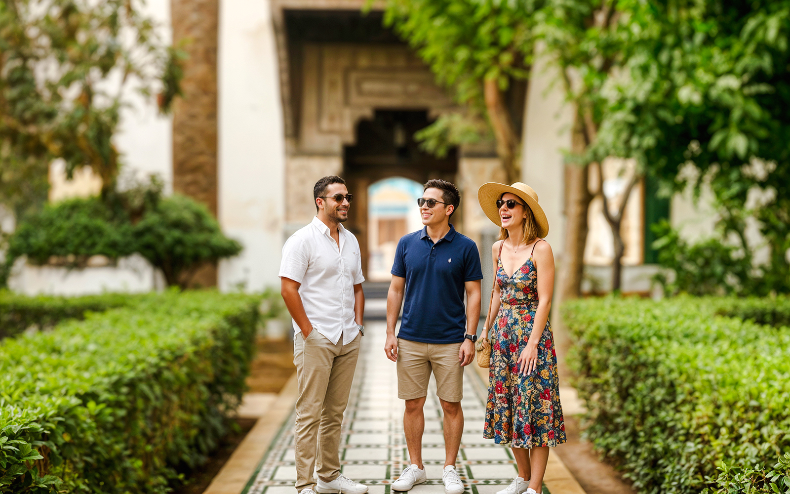 Visitors enjoying a guided tour at Bahia Palace gardens.