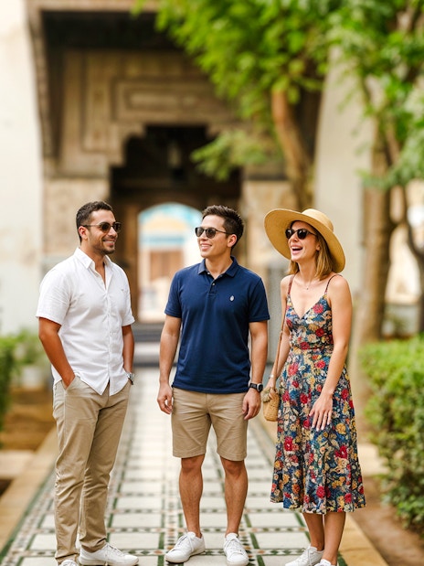 Visitors enjoying a guided tour at Bahia Palace gardens.