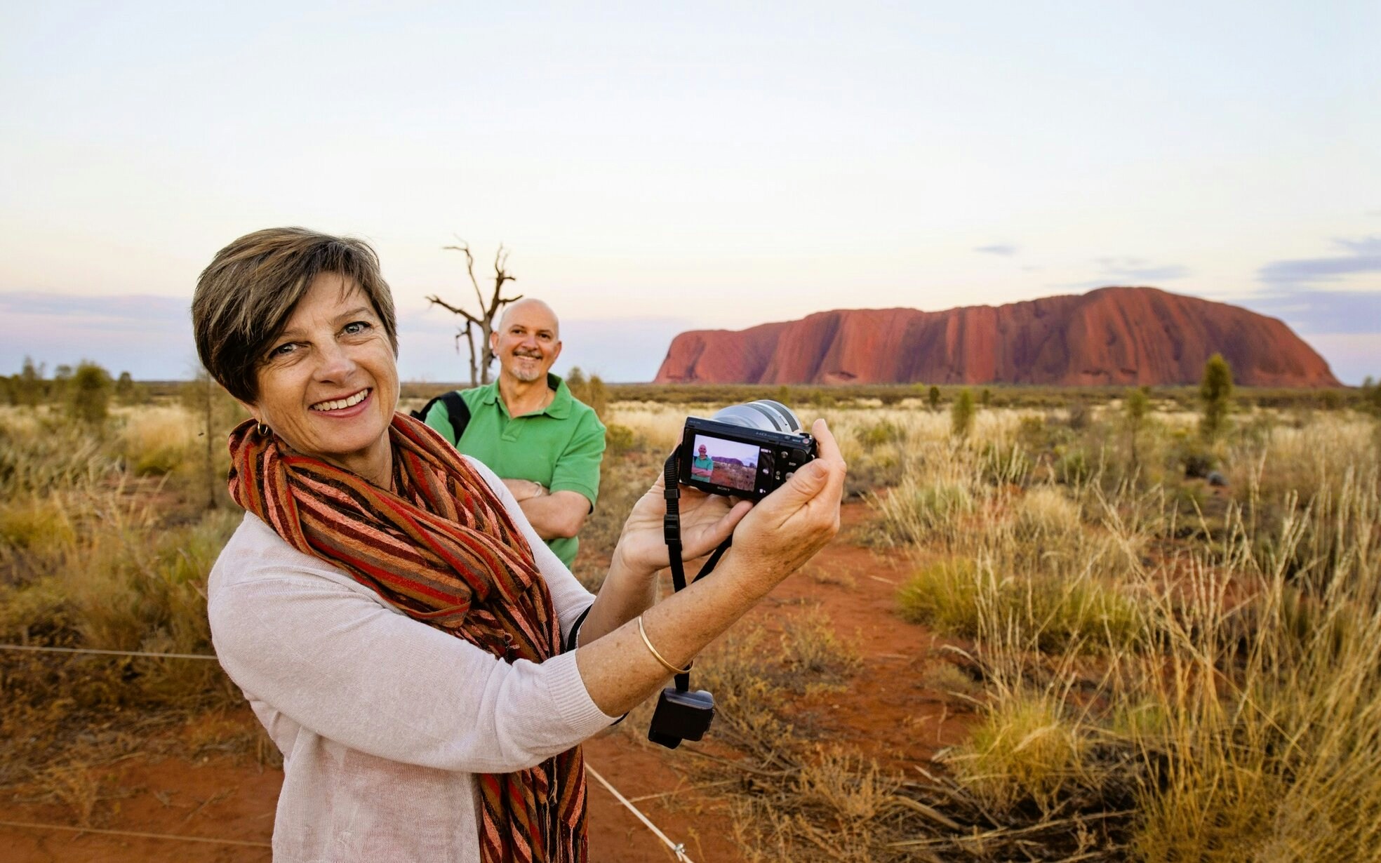 Uluru at sunset with grassland, Northern Territory, Australia.