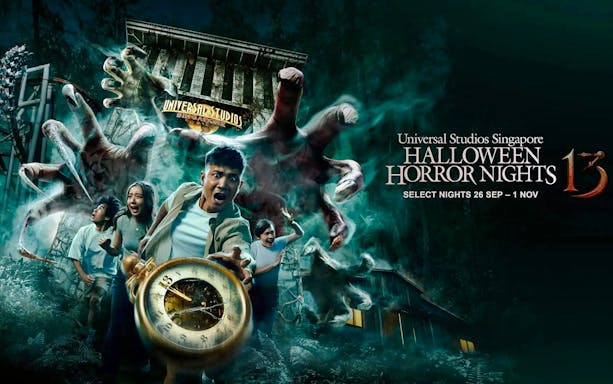 Visitors fleeing from giant hands at Universal Studios Singapore Halloween Horror Nights.