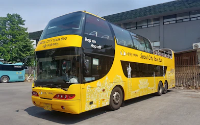 Yellow double-decker bus for Dongdaemun Hop-on Hop-off Tour in Seoul.