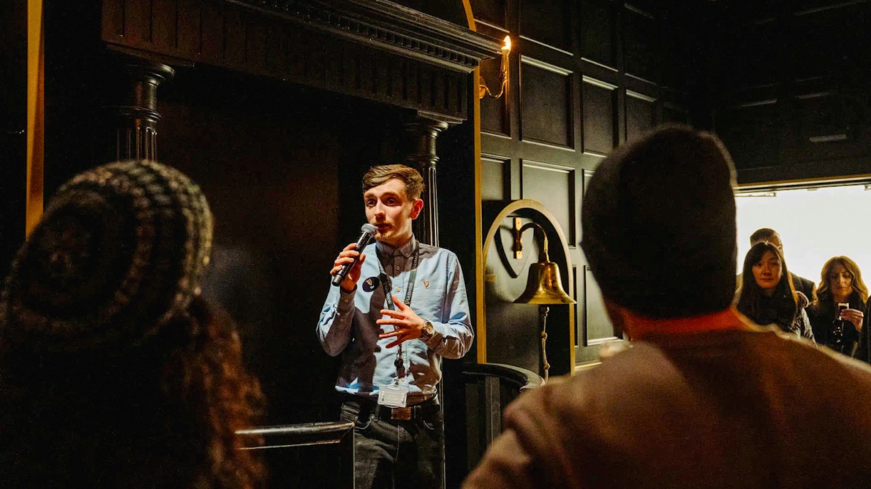 Tour guide speaking to visitors at Jameson Distillery, Dublin.