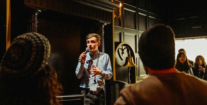 Tour guide speaking to visitors at Jameson Distillery, Dublin.