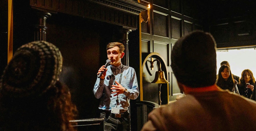 Tour guide speaking to visitors at Jameson Distillery, Dublin.