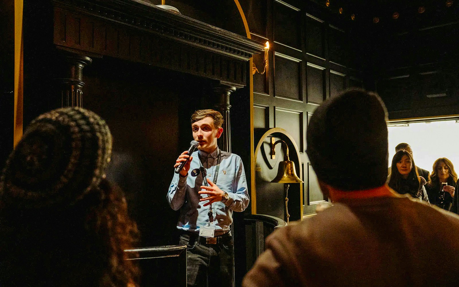 Tour guide speaking to visitors at Jameson Distillery, Dublin.