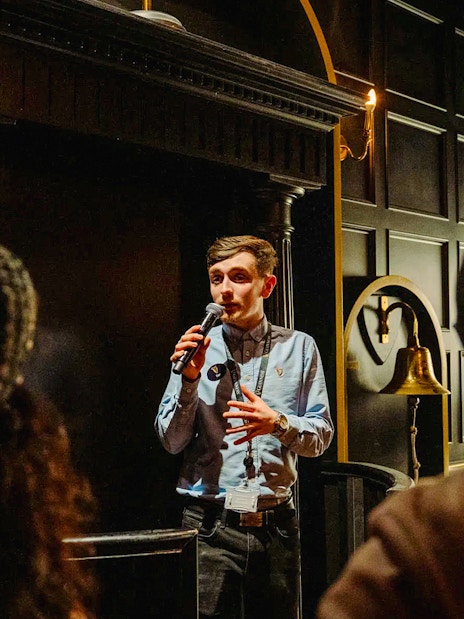 Tour guide speaking to visitors at Jameson Distillery, Dublin.
