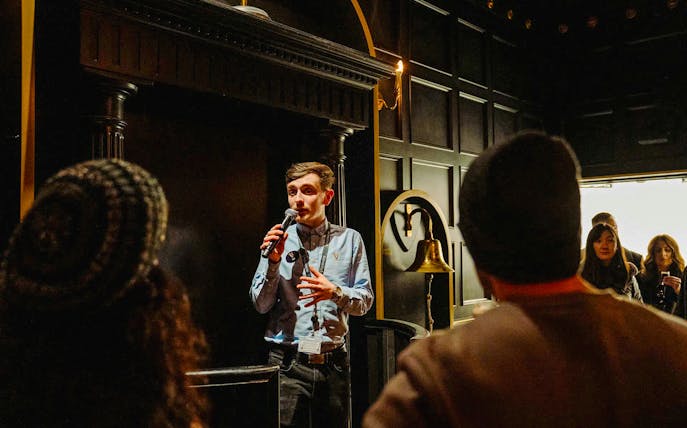 Tour guide speaking to visitors at Jameson Distillery, Dublin.